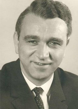 Black and white portrait photograph of man in formal suit